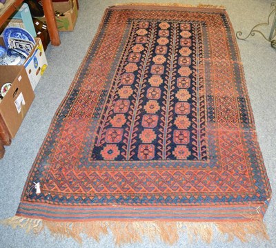 Lot 1308 - A Kurdish rug, North West Iran, the indigo field with columns of guls enclosed by madder...