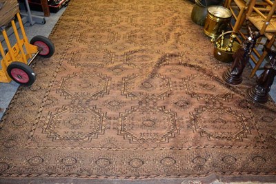 Lot 1310 - A Bokhara style rug, the central field of eighteen hooked medallions within a conforming border...