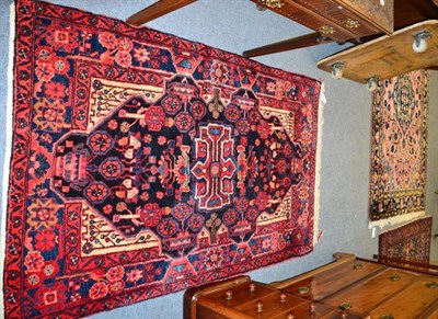 Lot 1318 - A Hamadan rug, Kurdistan, the faded coral field with central medallion, enclosed by indigo borders