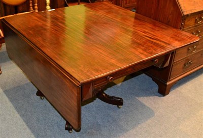 Lot 1324 - An early 19th century mahogany drop leaf table, single drawer with hinged baize insert, raised...