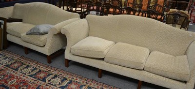 Lot 1325 - A pair of cream upholstered three seater sofas in George III style, modern