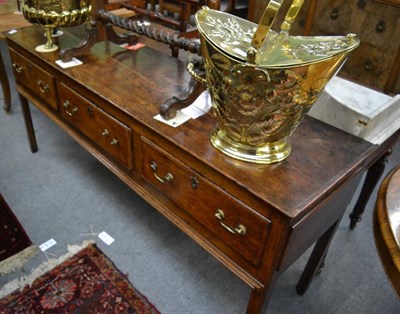 Lot 1338 - A George III oak three drawer dresser base