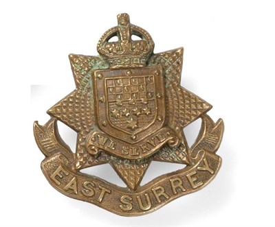 Lot 81 - A First World War Brass Cap Badge to the East Surrey Regiment, the solid back stamped...