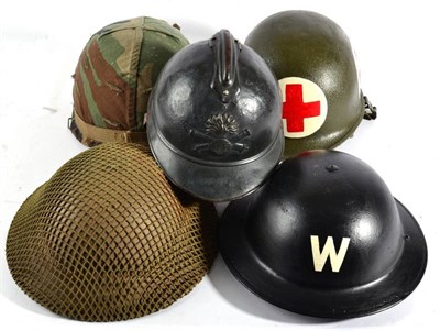 Lot 175 - Two Second World War Brodie Helmets, one with camouflage netting, the liner dated 1940, the...