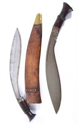 Lot 280 - A British Military Issue Kukri, the 34cm curved steel blade with two broad shallow fullers and...