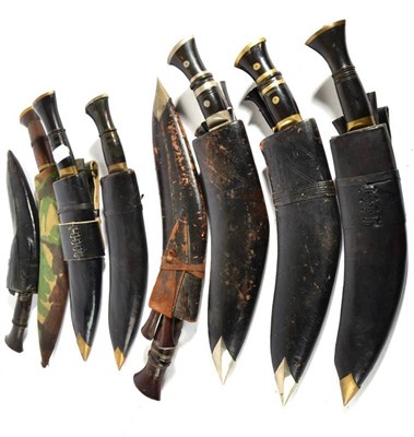 Lot 334 - A Collection of Six Kukris, each with horn hilt, nickel bolster and butt cap, with leather...