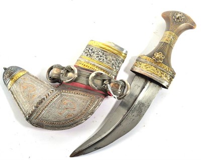 Lot 352 - An Omani Khanjar, the curved steel blade with raised medial ridge to each side, the horn grip...