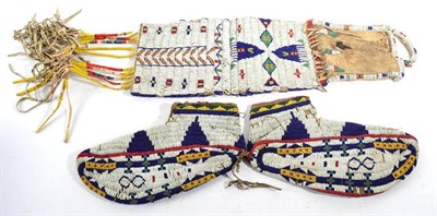 Lot 360 - A Pair of North American Native Beaded Sole Moccasins, decorated with geometric bands and...