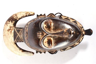 Lot 368 - A 19th Century Yaure Carve Wood Mask, Ivory Coast, the downward curving crescent shape...