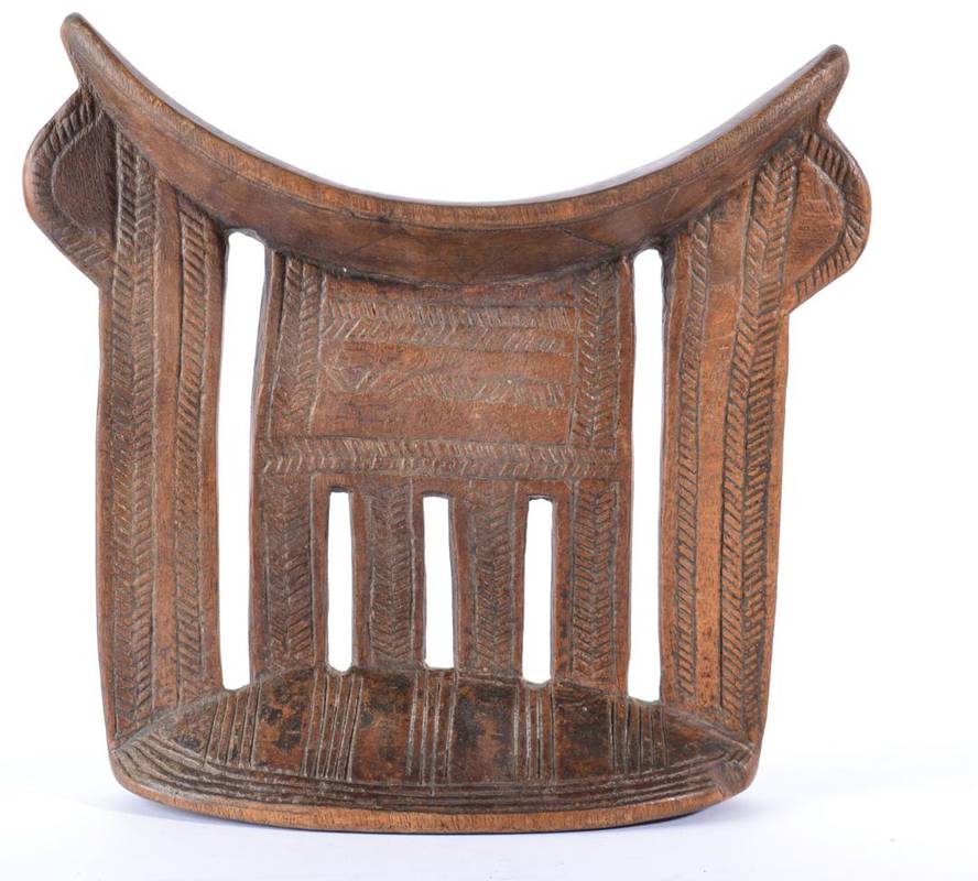 Lot 374 - A Shona Headrest, Zimbabwe, with curved top with a central comb shape support flanked by flat...