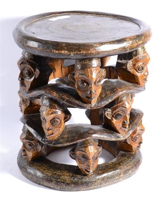 Lot 376A - A Bamileke (Cameroon), Anthropomorphic Stool, carved from a single trunk of wood, the circular seat