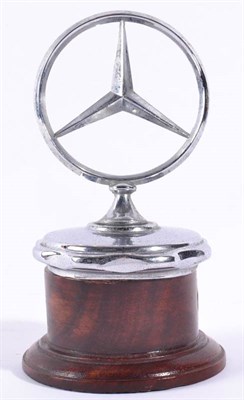 Lot 1017 - A Chrome Car Mascot for a Mercedes-Benz, mounted on a radiator cap and later stained wooden...