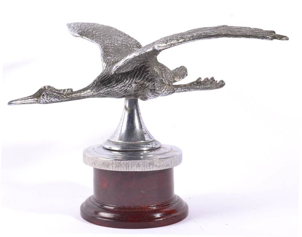 Lot 1029 - A Chrome on Brass Car Mascot, in the form of a heron with outswept wings, mounted on a chromed...