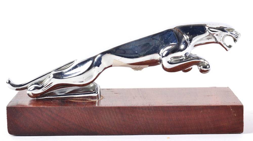 Lot 1033 - A Chromed Car Mascot, in the form of a leaping jaguar, mounted on a later stained mahogany...