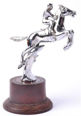 Lot 1034 - A Chrome on Brass Car Mascot, in the form of a horse and jockey on rearing legs, indistinctly...