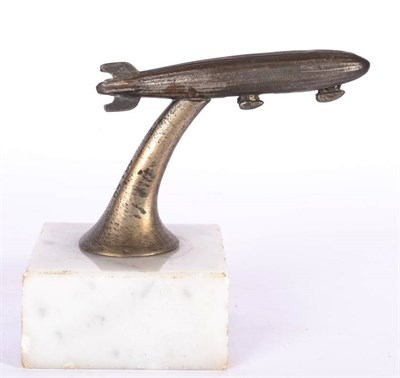 Lot 1036 - A 1920/30s Nickel on Brass Car Mascot, in the form of a stylised ZEPPELIN airship, the base stamped