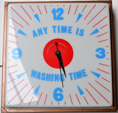 Lot 1061 - A 1950/60s Illuminated Metal Cased and Perspex Any Time is Washing Time Wall Clock, fitted for...
