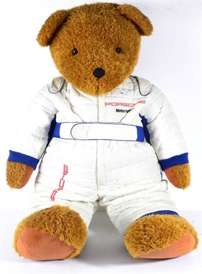 Lot 1140 - A Giant Porsche Motor Sport Advertising Teddy Bear, wearing a race suit, 100cm high approx