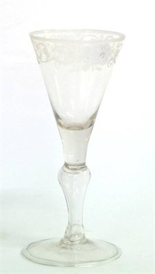 Lot 2 - A Light Baluster Wine Glass, circa 1750, the funnel bowl engraved with a band of scrolling foliage