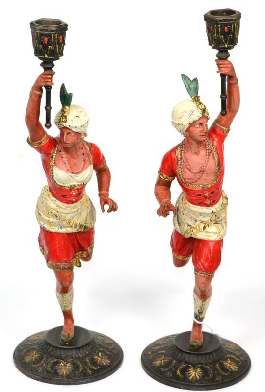 Lot 5 - A pair of cold painted spelter figural candlesticks, modelled as attendants in turbans
