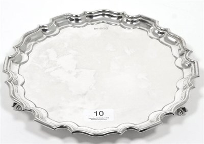 Lot 10 - A shaped circular silver salver, Walker & Hall, Sheffield 1919, on scroll supports, 26cm...