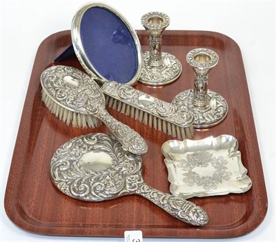 Lot 32 - A silver dressing table set including a pair of candlesticks; an oval photograph frame; and a...