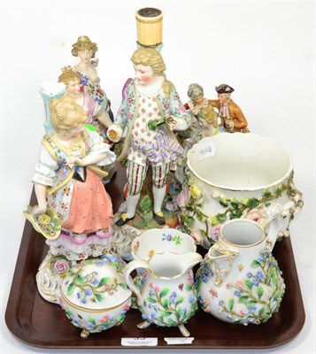 Lot 33 - A quantity of floral encrusted ceramics to include two Meissen style milk jugs, a bowl and cover, a