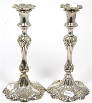 Lot 40 - A pair of electroplated candlesticks with foliate decoration