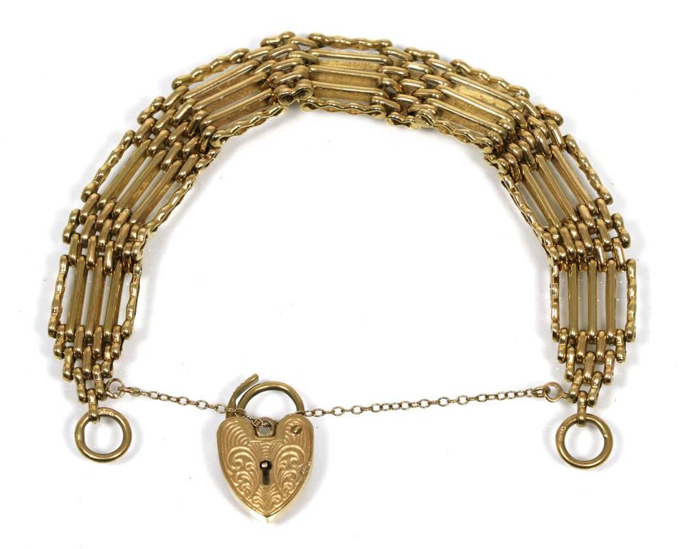 Lot 57 - A 9 carat gold gate link bracelet with heart shaped padlock clasp