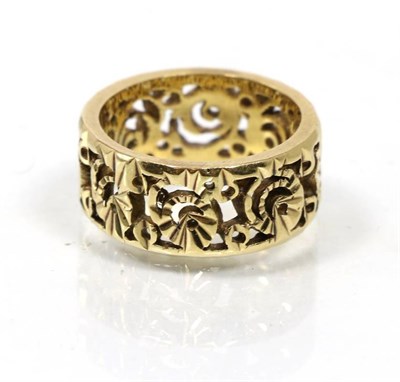 Lot 97 - An 18 carat gold band broad ring, with pierced motif, finger size L