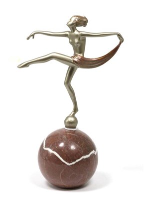 Lot 112 - An Art Deco patinated spelter figure, on a marble ball base, 23cm
