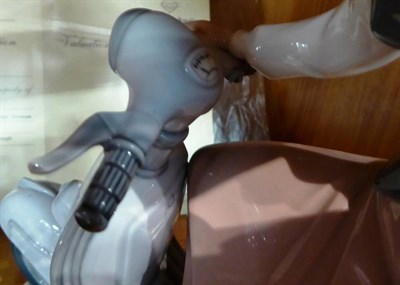 Lot 122 - Lladro china figure, Girl with Motor Scooter, No.5143, with wood base