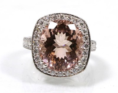 Lot 144 - An 18 carat white gold morganite and diamond cluster ring, an oval cut morganite in a double...