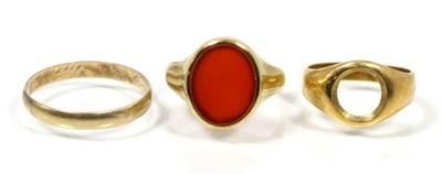 Lot 145 - A yellow metal signet ring; an 18 carat gold signet ring (a.f.); and a 14 carat gold band ring (3)