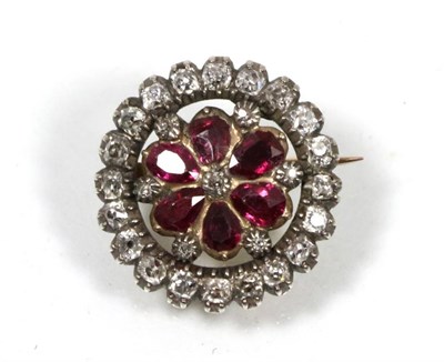 Lot 146 - A ruby and diamond brooch, a central old cut diamond within a border of pear cut rubies and an...