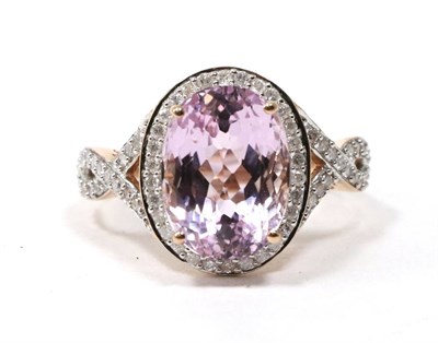 Lot 157 - A 14 carat rose gold kunzite and diamond cluster ring, an oval cut kunzite within a diamond border