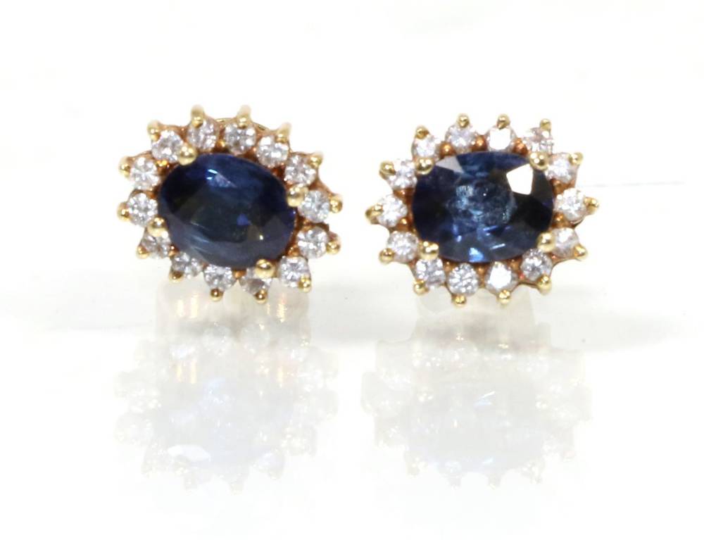 Lot 164 - A pair of sapphire and diamond cluster earrings, total estimated diamond weight 0.15 carat...