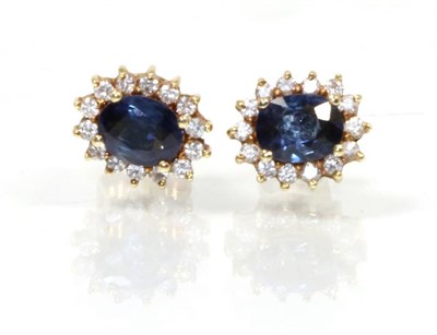 Lot 164 - A pair of sapphire and diamond cluster earrings, total estimated diamond weight 0.15 carat...