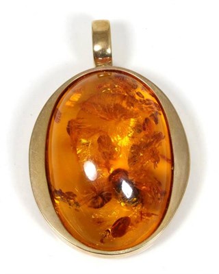 Lot 175 - A 9 carat gold amber pendant, measures 7cm by 5cm, 35.2g