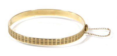 Lot 181 - A 9 carat gold bangle, with faceted design, 11.8g