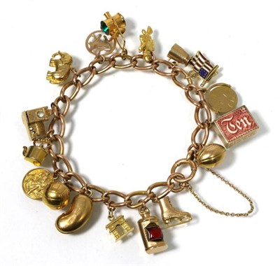 Lot 183 - A 9 carat gold charm bracelet, with 17 gold charms, 38.5g