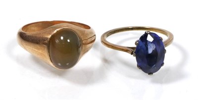 Lot 197 - A cabochon set signet ring, finger size M1/2 and a synthetic sapphire ring, finger size K1/2,...
