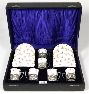 Lot 227 - An Aynsley coffee service decorated with roses and with pierced silver holders, in a fitted case