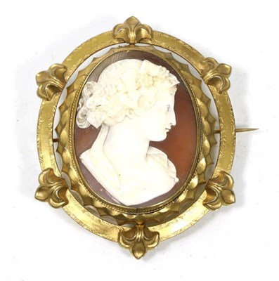 Lot 241 - A Victorian cameo brooch, depicting the bust of a Bacchante, in a gilt metal frame, measures 8cm by