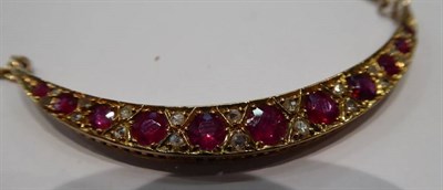 Lot 257 - A ruby and diamond crescent necklace, graduated round cut rubies spaced by rough cut diamonds,...
