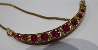 Lot 257 - A ruby and diamond crescent necklace, graduated round cut rubies spaced by rough cut diamonds,...