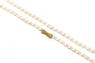 Lot 266 - An Akoya cultured pearl necklace with a bow shaped clasp , length 91cm, stamped '14K'