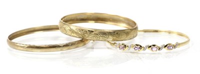 Lot 267 - A 9 carat gold amethyst and diamond bangle, a 9 carat gold foliate engraved hinge opening...