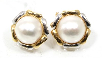 Lot 270 - A pair of mabe pearl earrings, in white and yellow metal borders, with clip fittings, measure 1.9cm