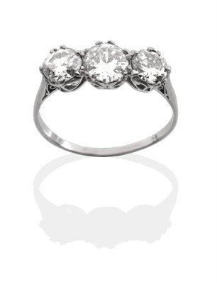 Lot 212 - A Diamond Three Stone Ring, three graduated round brilliant cut diamonds in white claw settings...